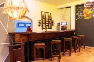a bar with stools in a room with a counter at Chiller Jone's place in Tangalle