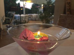 a candle in a glass bowl on a table at Vera Bed and Breakfast in Umag