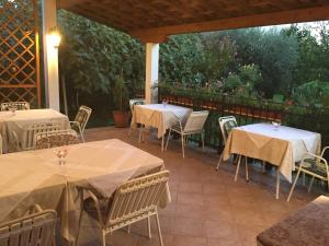 an outdoor patio with tables and chairs and a fence at Vera Bed and Breakfast in Umag