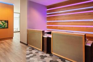 a waiting room with purple walls and brown dividers at TownePlace Suites by Marriott New Orleans Downtown/Canal Street in New Orleans