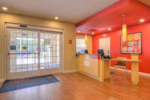 an office with a desk in a room with orange walls at TownePlace Suites Arundel Mills BWI Airport in Hanover +16 photos