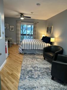 a bedroom with a bed and a couch and a chair at Lakefront King Studio with Private Porch in Tilton