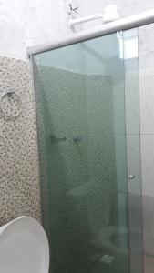 Un baño con ducha de cristal con inodoro. en Porto apartamento 1, en Porto Seguro 21 fotos más