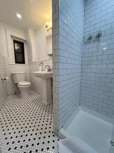 a bathroom with a tub and a toilet and a sink at Share this Historic Brownstone with the Host! in Brooklyn +17 photos