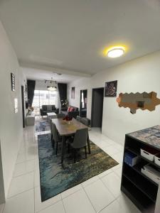 a dining room and living room with a table and chairs at Amy Homestay in Brinchang