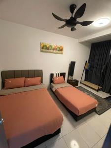 a bedroom with two beds and a ceiling fan at Amy Homestay in Brinchang +5 photos