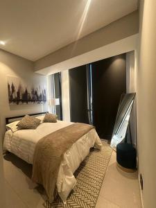 a bedroom with a bed and a large window at Apartment with city views central area in Guadalajara +8 photos