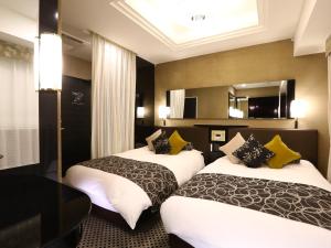 Postel nebo postele na pokoji v ubytování APA Hotel Iidabashi Ekimae