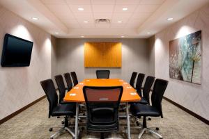 a conference room with an orange table and chairs at SpringHill Suites Hartford Airport/Windsor Locks in Windsor Locks +11 photos