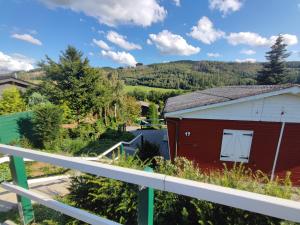 a view from the balcony of a red barn at Ferienhaus Bergblick Urlaub mit Hund in Meschede