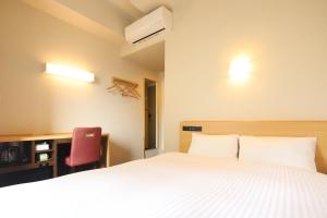 Llit o llits en una habitació de AB Hotel Anjo
