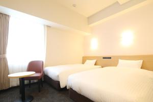 Llit o llits en una habitació de AB Hotel Anjo