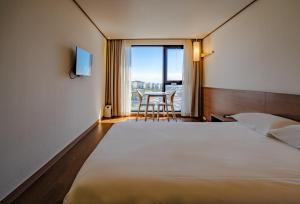 Postel nebo postele na pokoji v ubytování Tamara Jeju hotel + 37 fotografií