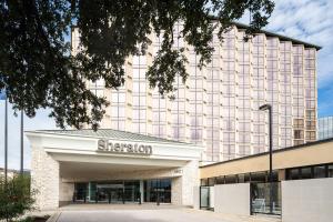 a building with a sign on the front of it at Sheraton Dallas Hotel by the Galleria in Dallas