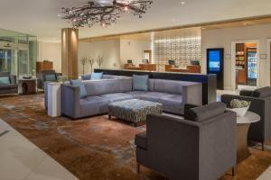 a living room with a couch and chairs at Sheraton Dallas Hotel by the Galleria in Dallas
