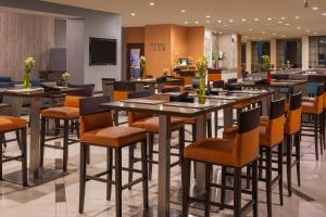 a restaurant with tables and chairs in a lobby at Sheraton Dallas Hotel by the Galleria in Dallas