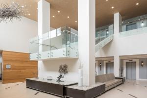 a living room with a staircase in a house at Sheraton Dallas Hotel by the Galleria in Dallas