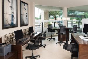 an office with two desks with computers and chairs at Sheraton Dallas Hotel by the Galleria in Dallas