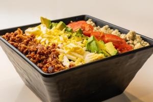 a black container filled with vegetables and meat at Sheraton Dallas Hotel by the Galleria in Dallas