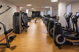 a gym with a row of treadmills and machines at Sheraton Dallas Hotel by the Galleria in Dallas
