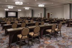 a conference room with tables and chairs and a screen at Sheraton Dallas Hotel by the Galleria in Dallas