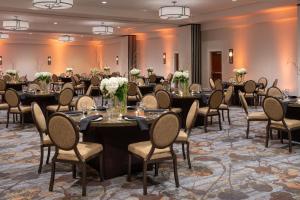 a group of tables and chairs in a room at Sheraton Dallas Hotel by the Galleria in Dallas +37 photos