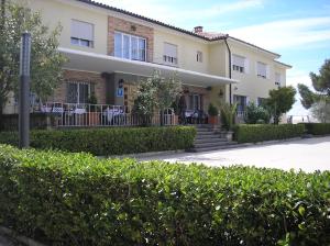 a large house with bushes in front of it at Hotel Santa Barbara in Andorra