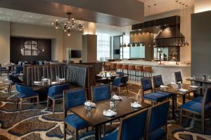 a restaurant with tables and chairs and a bar at Morgantown Marriott at Waterfront Place in Morgantown