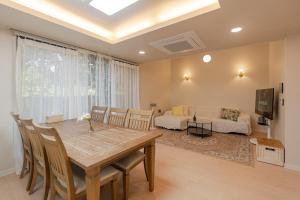 a dining room with a table and a bedroom at 32평자쿠지독채 지금애월 in Jeju