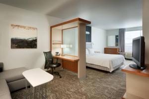 a hotel room with a bed and a desk at SpringHill Suites by Marriott Rexburg in Rexburg +20 photos