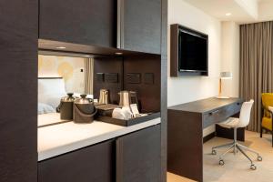 a hotel room with a desk and a bed at Le Royal Meridien Beach Resort & Spa Dubai in Dubai