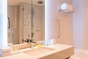 a bathroom with a sink and a large mirror at Le Royal Meridien Beach Resort & Spa Dubai in Dubai