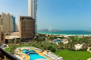 a view of a resort with a pool and the ocean at Le Royal Meridien Beach Resort & Spa Dubai in Dubai