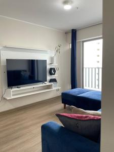 a living room with a large television and a couch at Amplio y Calido Departamento en Ubicación Centrica in Lima +17 photos