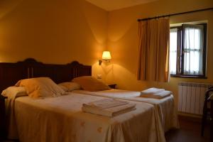 a bedroom with a bed with two towels on it at La Fonte in Naves