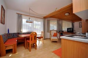 cocina y sala de estar con mesa y sillas en Appartements Familie Grundner, en Leogang