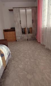 a room with a bed and some cabinets and a floor at Квартира рядом с Караколом in Karakol