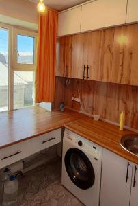 a kitchen with a washing machine and a sink at Квартира рядом с Караколом in Karakol
