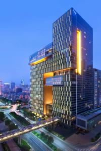 a tall building with a highway in front of it at W Guangzhou in Guangzhou
