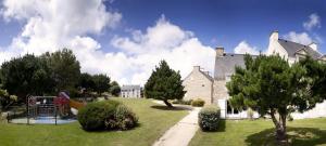 a large house with a playground in the yard at Residence Port du Crouesty - maeva Home in Arzon