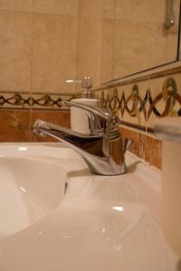 a bathroom sink with a chrome faucet on it at Apartman Marija Medjugorje in Međugorje