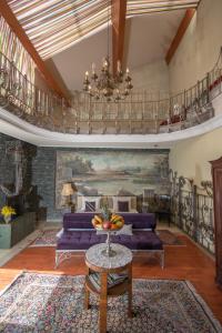 a living room with a purple couch and a chandelier at Hotel Michele in Sarajevo