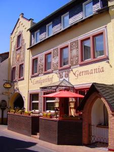 a building with a red umbrella in front of it at Landgasthof Germania in Rüdesheim am Rhein
