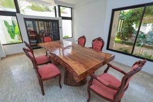 Un comedor con mesa y sillas de madera. en Villa Rosa Cotonou, en Cotonou