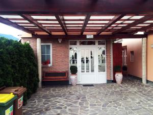 a patio with a white door and a brick building at Apartments Bogdanovic in Maribor