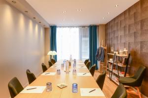 a conference room with a long table and chairs at ZE Hotel in Paris
