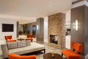 a living room with a couch and a fireplace at Sheraton Philadelphia University City Hotel in Philadelphia
