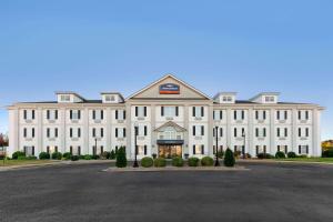 a large white building with a lot of windows at Howard Johnson by Wyndham Jackson in Jackson