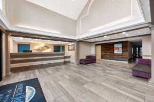 a lobby with purple chairs and a waiting room at Howard Johnson by Wyndham Jackson in Jackson