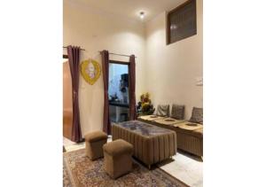 a living room with a couch and a mirror at Raghav Vilas in Varanasi